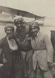 Portrait of Three Men Smiling in Front of an Airplane