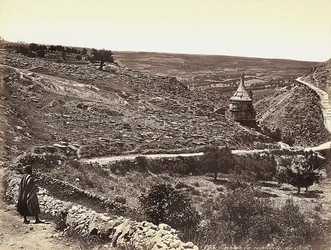 Panoramic view of the Valley of Cedron or Josafat, with the Tomb of Absalom, on the outskirts of Jerusalem. A man is looking at the view from the street