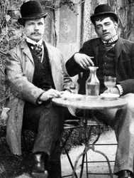 A chatelain (Ducos) and his coachman sitting on the terrace of a café and drinking absinthe - photograph, circa 1890