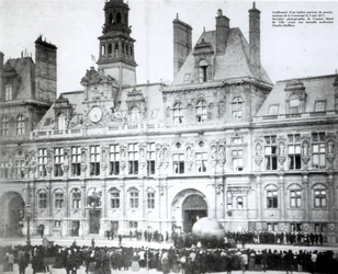 Inflating a balloon with the declarations of the Commune attached to it outside the Hotel de Ville, Paris