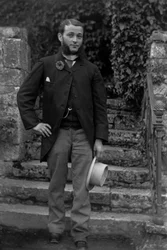Portrait of a Young Man from Bourmont in Haute Marne, Wearing the Cockade of Conscripts at the Buttonhole, Posing in the Garden of the Abbey of Septfontaines. Photography Late 19th Century. Ducos Collection