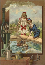 Boy demonstrating toy steam boat to girl