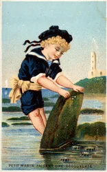 Boy Looking Under Stone on Beach