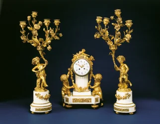 Garniture retailed by Black, Starr and Frost comprising a mantel clock and pair of four-light candelabra, c.1875-1900