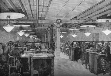 Room of female telegraphers in the central office of the Ministry of Posts and Telegraphs illuminated with electric light by voltaic arc lamps, Paris 1883