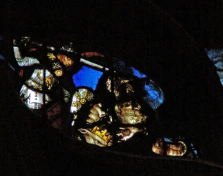The west rose window depicting a scene from the Book of Revelation: War in heaven; St Michael conquers the dragon