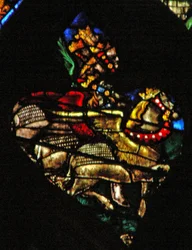 The west rose window depicting a scene from the Book of Revelation: Locusts as horses prepared for battle, with heads like men, hair like women and tails like scorpions (9:7 10)