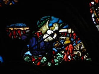 The west rose window depicting a scene from the Book of Revelation: An angel taking the altar fire and casting it upon the earth