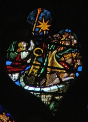 The west rose window depicting a scene from the Book of Revelation: Fifth trumpet; the star falls from heaven, the key to the bottomless pit, and a huge locust