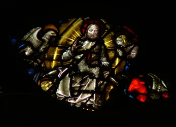 The west rose window depicting a scene from the Book of Revelation: Lamb before the throne, between the four sacred living creatures