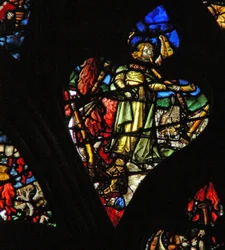 The west rose window depicting a scene from the Book of Revelation: Second trumpet; a burning mountain descends into the sea