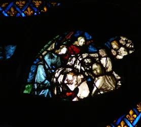 The west rose window depicting a scene from the Book of Revelation: Souls being arrayed in white robes by angels