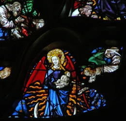 The west rose window depicting a scene from the Book of Revelation: Woman clothed as the sun, the moon under her feet and twelve stars in her nimbus