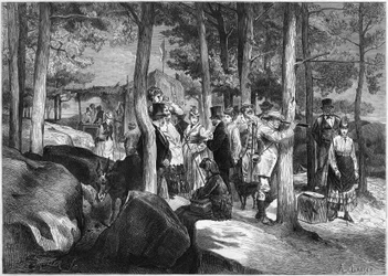 Tourists at the gorges of Apremont, near the entrance of the cave, in the forest of Fontainebleau