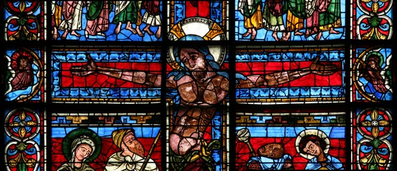 Window depicting the Crucifixion with the sun and moon