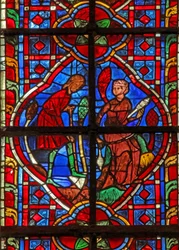 Window depicting Adam delves while Eve spins