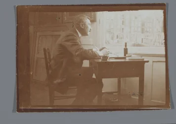 Willem Witsen at a desk in his boat
