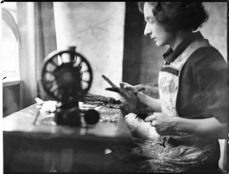 A glover working at a sewing machine