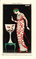 Woman in house gown of coral-print silk over a linen petticoat. Aquarium with coral and goldfish