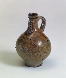 Bartmannkrug or Bellarmine wine bottle decorated with an applied bearded face mask, Germany, c.1630-40