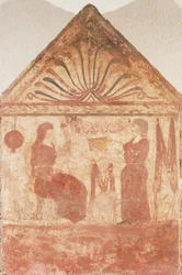 Painted tombstone showing Woman seated on throne in act of spinning