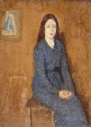 A sitting Girl wearing a Spotted Blue Dress