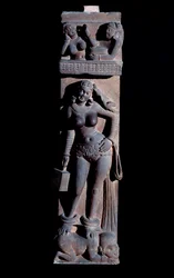Representation of a Yakshini spirit of nature, holding a cage and a parrot, she stands on a dwarf. Sculpture by Mathura, sandstone, 2nd century