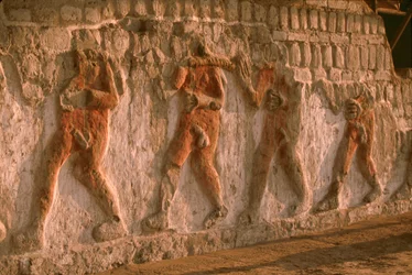 Frieze of naked prisoners of the Moche on the Huaca Cao Viejo walls in El Brujo