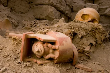 Bones of the female sacrifice a ceramic of a man sitting under a roof., 2005