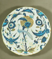 Iznik dish painted with a peacock perched among flowers, Turkey, c. 1550-55