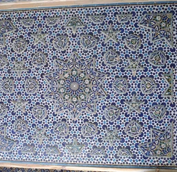 North portal tile panel, one of a pair with protruding palmettes and stars encircling the central sun medallion