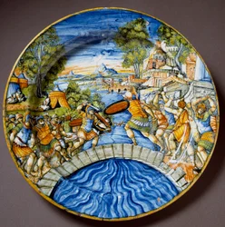 Episode from the defence of the Sublician Bridge by the legendary Roman hero Horatius Cocles during the fighting against the Etruscans. Ceramic plate produced in Urbino in the Fontana workshop, Italy. Around 1560. Florence, Museo Nazionale del Bargello