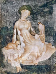 Woman sitting on ground with dog and falcon