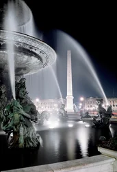 View of the fountain made by Jacques Ignace Hittorff and the obelisk of Place de la Concorde in Paris
