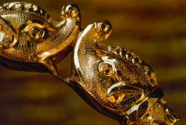 Hand crafted gold bracelet featuring two shark heads colliding