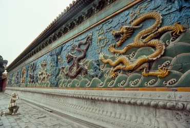 Woman photographs the Nine-Dragon Screen in Beihai Park, Beijing