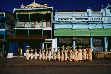 Buddhist Nuns of Various Ages Parade on the Sidewalk Soliciting Alms, Maymyo, Burma