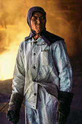 Chinese Man Steelworker in Protective Clothing at a Steel Mill in China