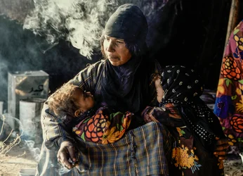 Syrian Bedouin Woman with Her Small Children in a Tent