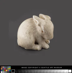 Netsuke modeled as a hare with amber eyes