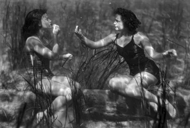 Women underwater applying lipstick in tourist attraction, Florida