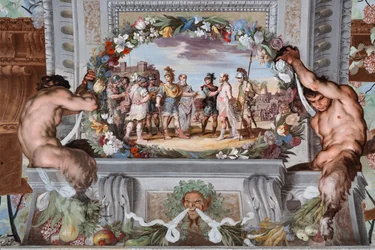 Acete, held prisoner by two soldiers, narrates the deeds of Bacchus to Pentheus and his retinue of warriors