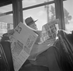 Reading war news aboard San Francisco streetcar