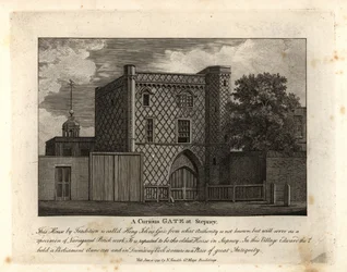 A curious gate in variegated brickwork called St John Gate, the oldest house in Stepney