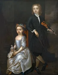 A young boy holding a violin and a young girl holding a doll
