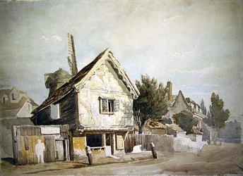 A street with old houses, a windmill beyond