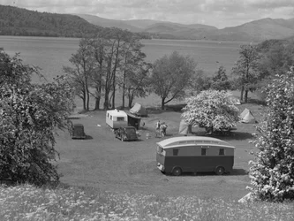 Tents and caravans in a field at Wastwater, lake and hills in background
