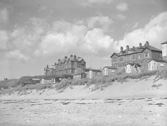 View from Silloth beach of beach huts and houses along seafront