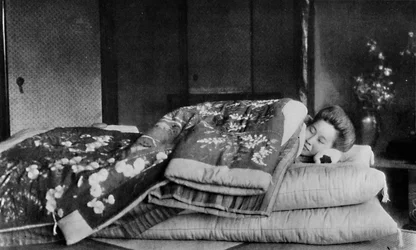 Saki, the housekeeper sleeps on a mattress with hard pillow under a quilted kimono