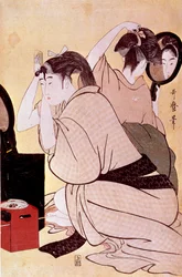 Two women have their hairstyles: one looks at herself in the mirror while the other combs. Japanese print by Utamaro Kitagawa. 1794-1795. Paris, Guimet Museum, National Museum of Asian Arts